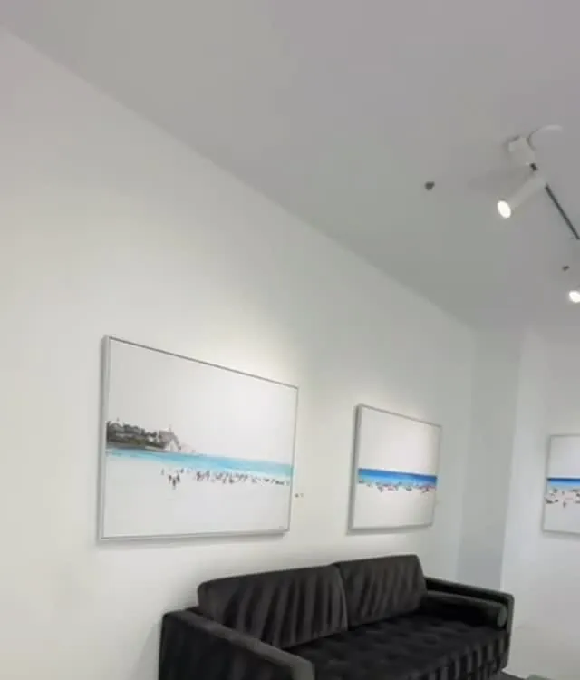 Lounge with black sofa and framed art