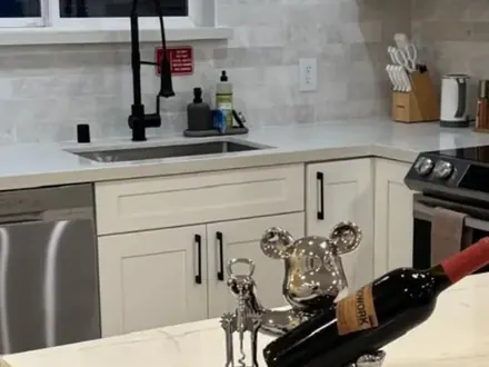 Clean white kitchen with stainless appliances