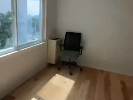 Empty bedroom with clean wood floor after move-out